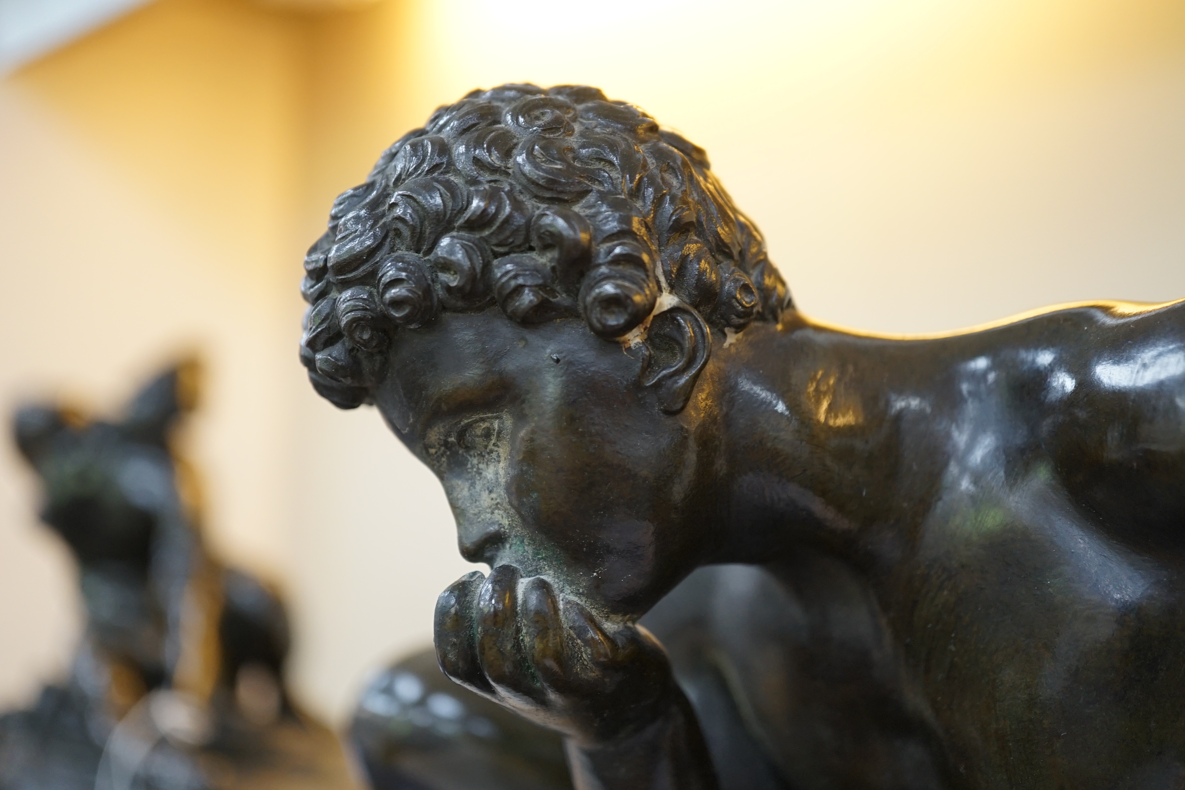 After the antique, a pair of late 18th/early 19th century Grand Tour souvenir bronze figures of seated warriors